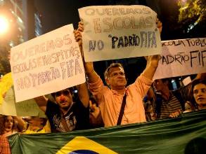 Antonio Carlos Costa and volunteers from Rio de Paz protesting in the streets of Rio de Janeiro asking the government for “FIFA Quality” Hospitals and Schools.  Photo by: Gabriel Telles