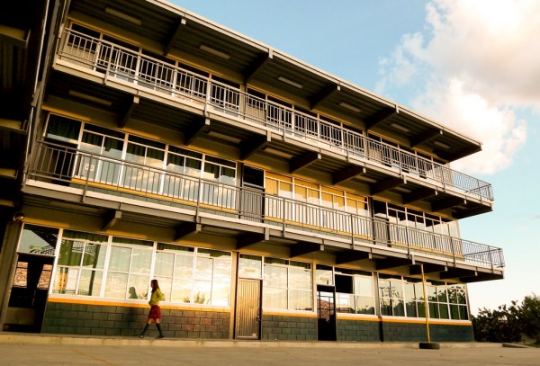 Female student walking by building
