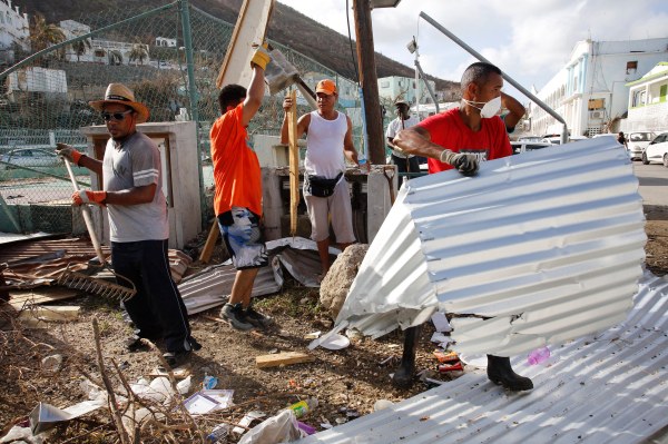 A group of man clear debris 
