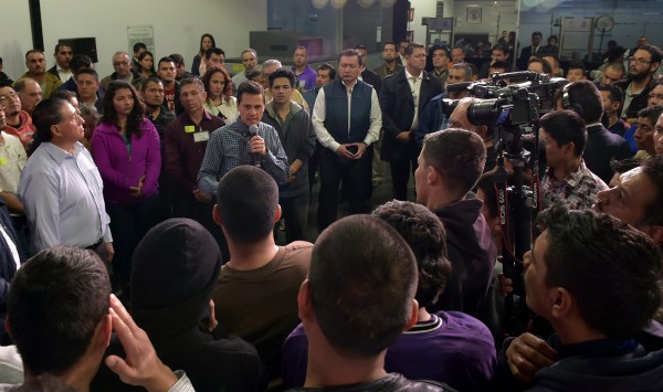 A large group of people gathers in an airport.