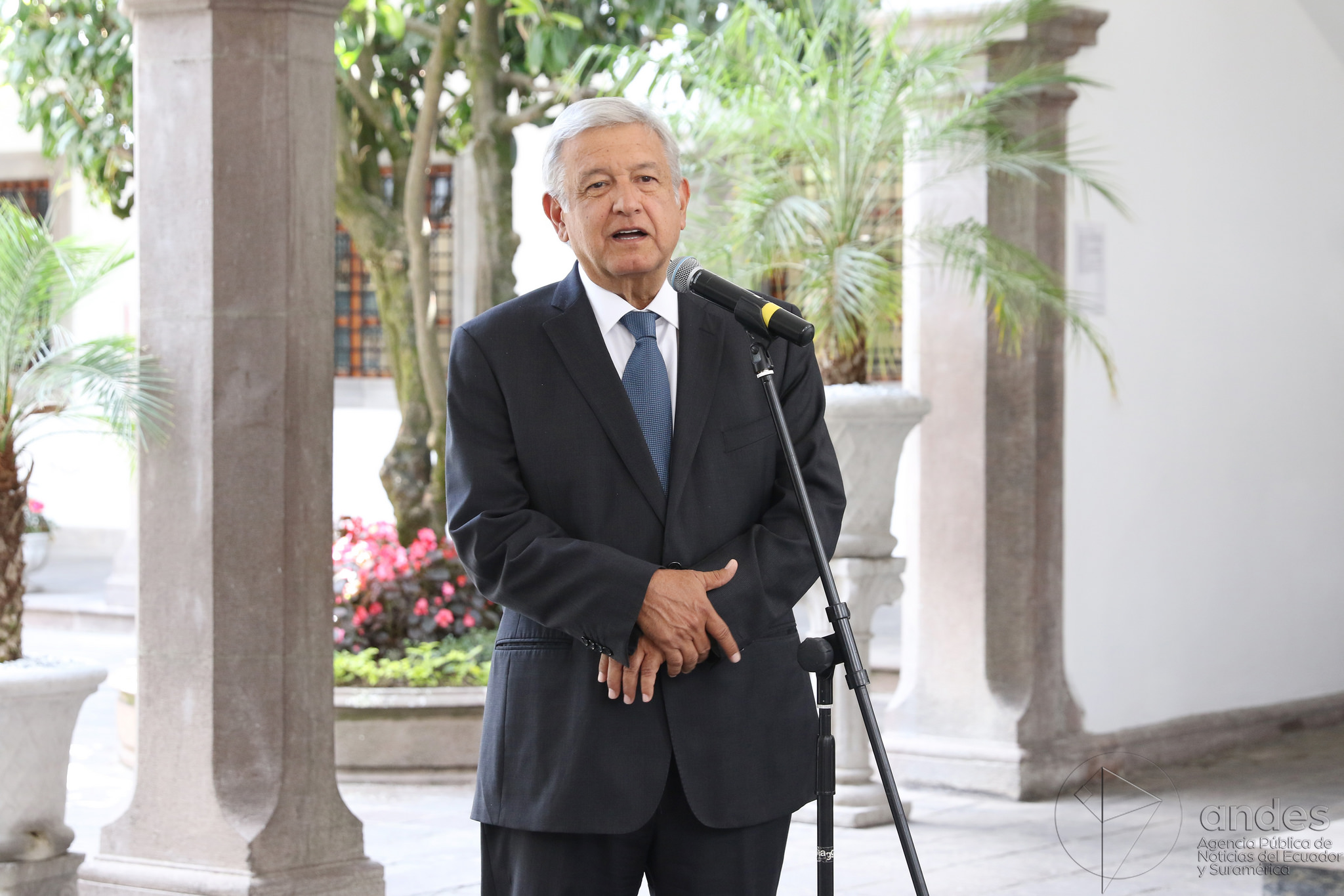 Andrés Manuel López Obrador stands at a microphone