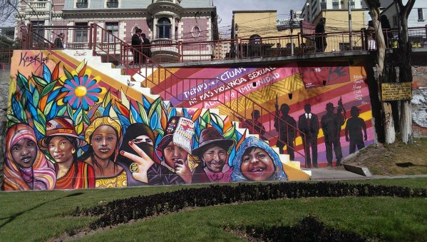 Image of colorful mural with diverse images of women. Text in the mural says: "It is time to act, no more sexual violence. No more impunity"