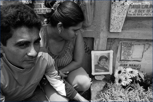 Family members of slain gang member at his gravesite