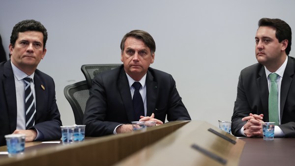 Moro, Bolsonaro, and Paraná governor Ratinho Júnior seated during a visit to the Integrated Center of Intelligence and Public Security of the Southern Region in May 2019.