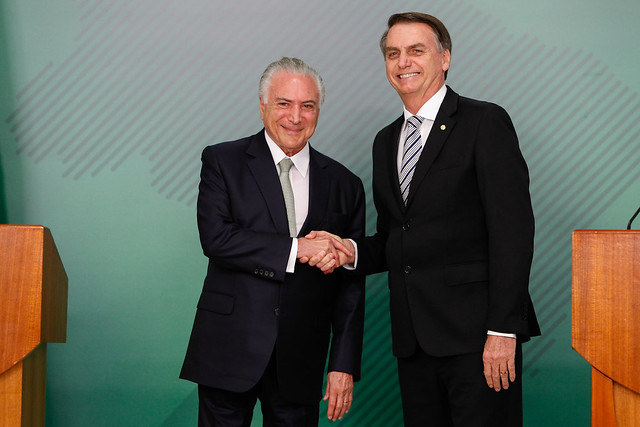 Current Brazilian President Jair Bolsonaro shaking hands with former President Michel Temer