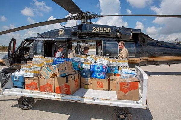 Men loading supplies onto a helicopter