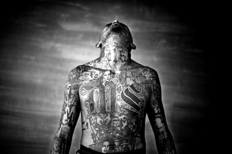 A member of the Mara Salvatrucha gang displays his tattoos inside the Chelatenango prison in El Salvador.